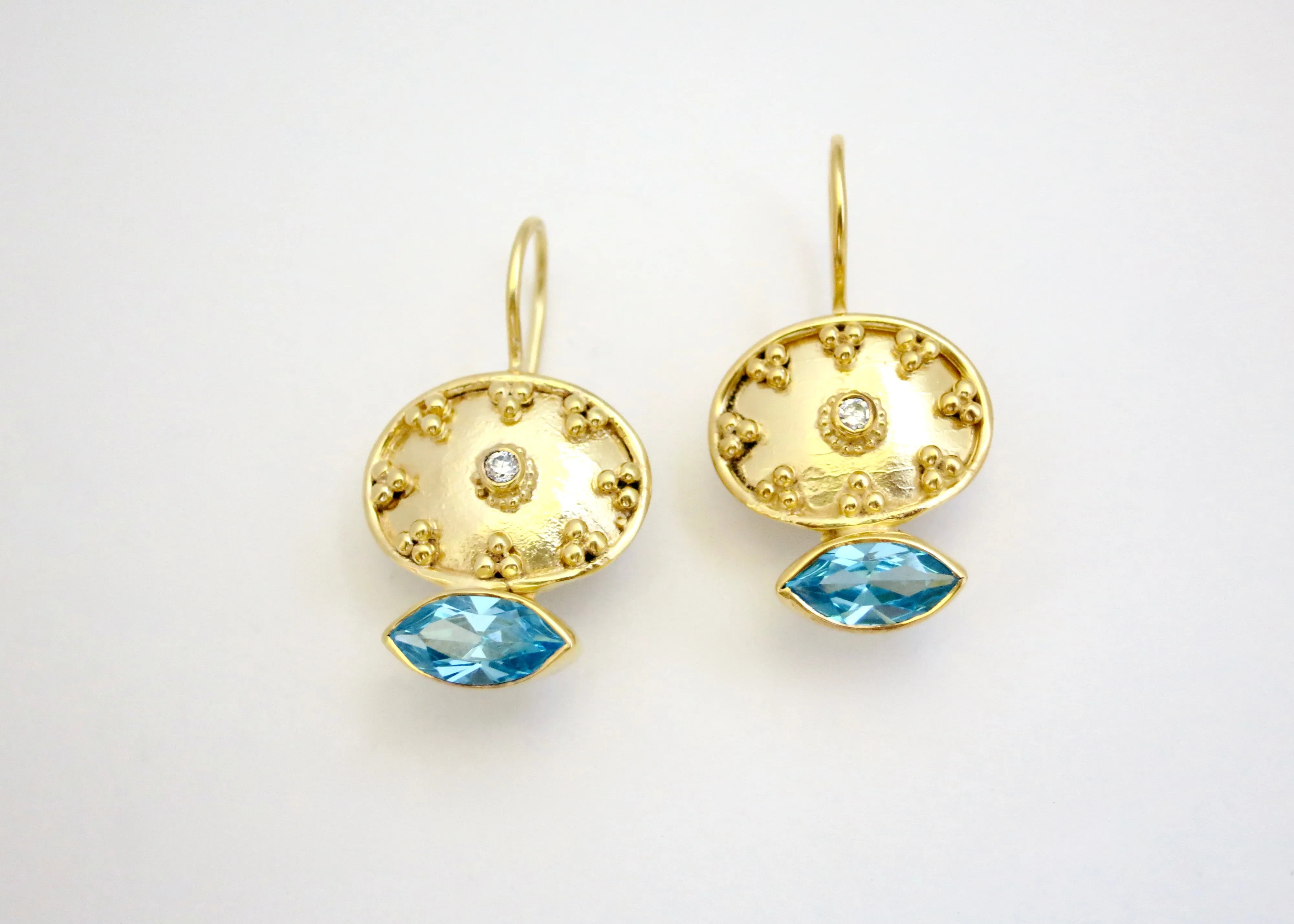 Ethereal, gold-plated oval earrings with navette shape blue topaz