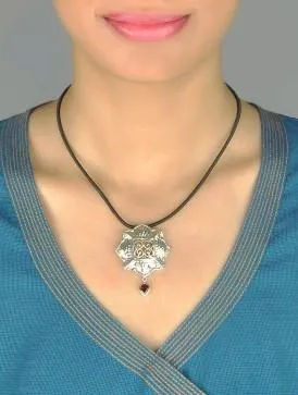 Gorgeous, Kutchi, 8 petal floral hammer finish pendant with jali work & a garnet drop