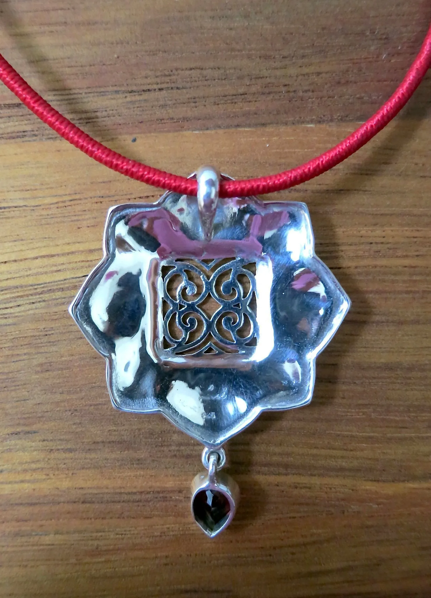 Gorgeous, Kutchi, 8 petal floral hammer finish pendant with jali work & a garnet drop
